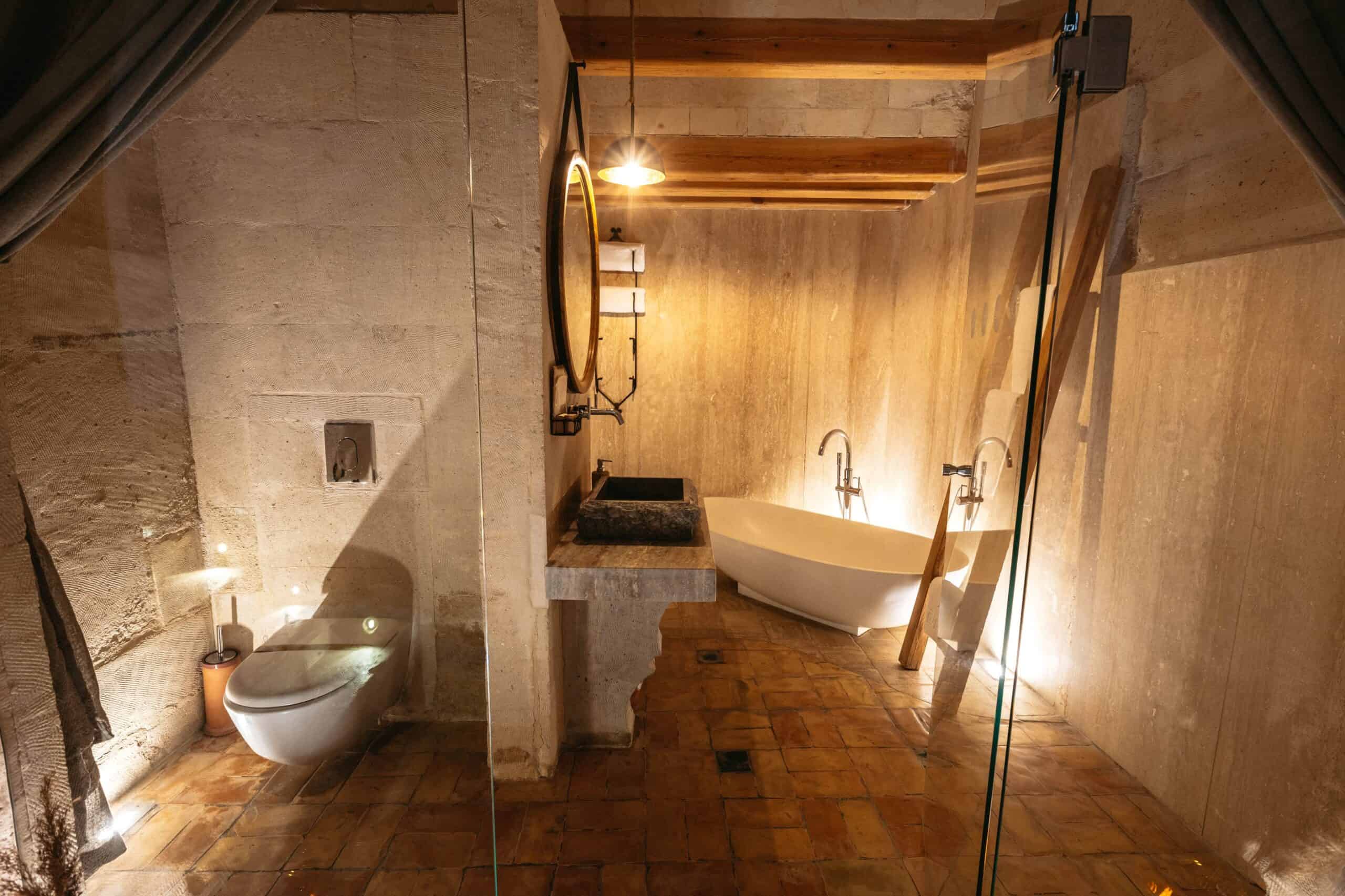 Junior Suite: stone bathroom with freestanding bathtub