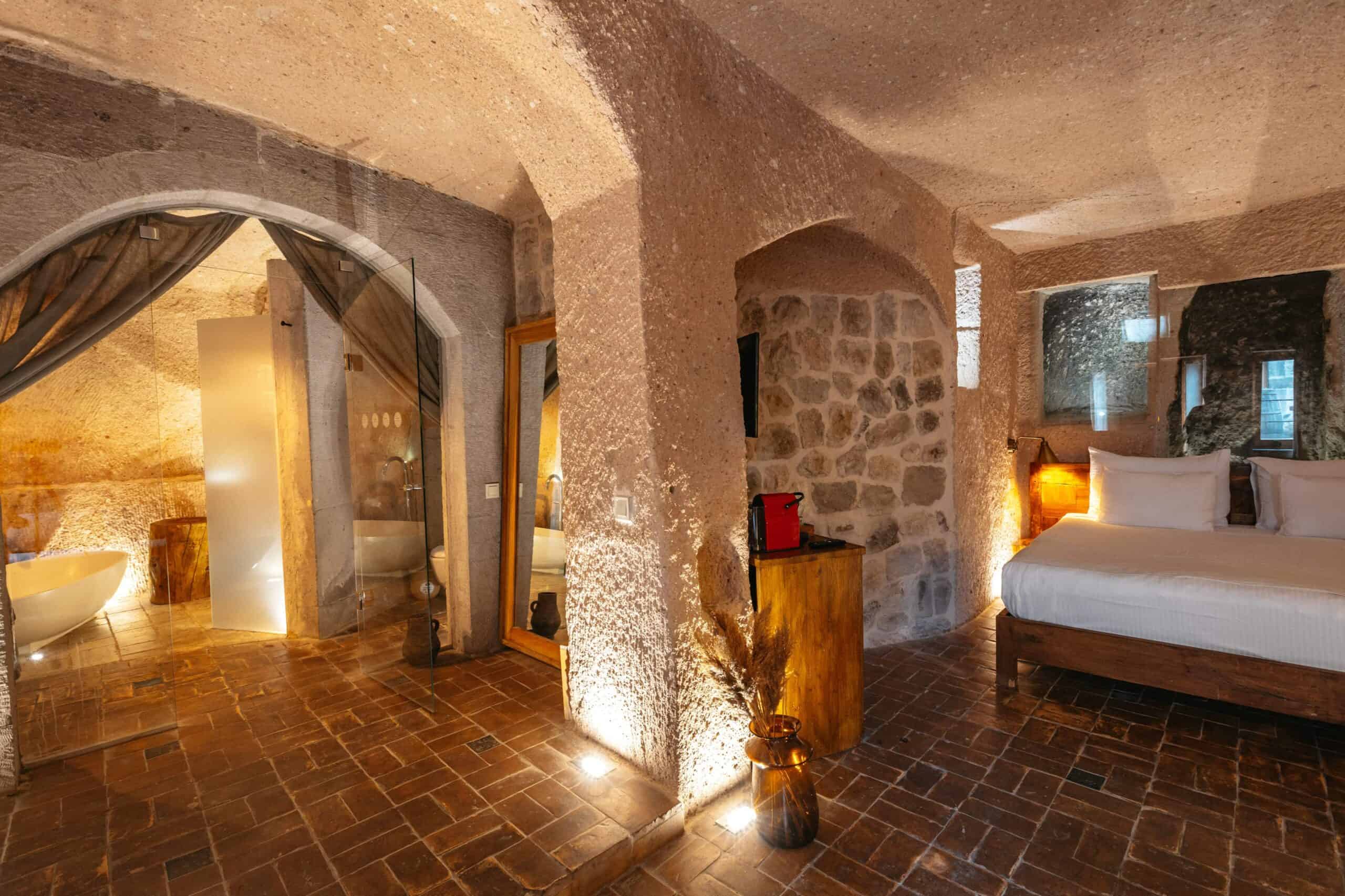 Junior Suite: cave room with stone arches and double bed