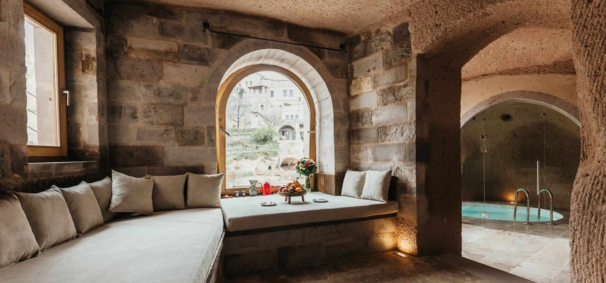 Cave suite living area with sofa and indoor pool