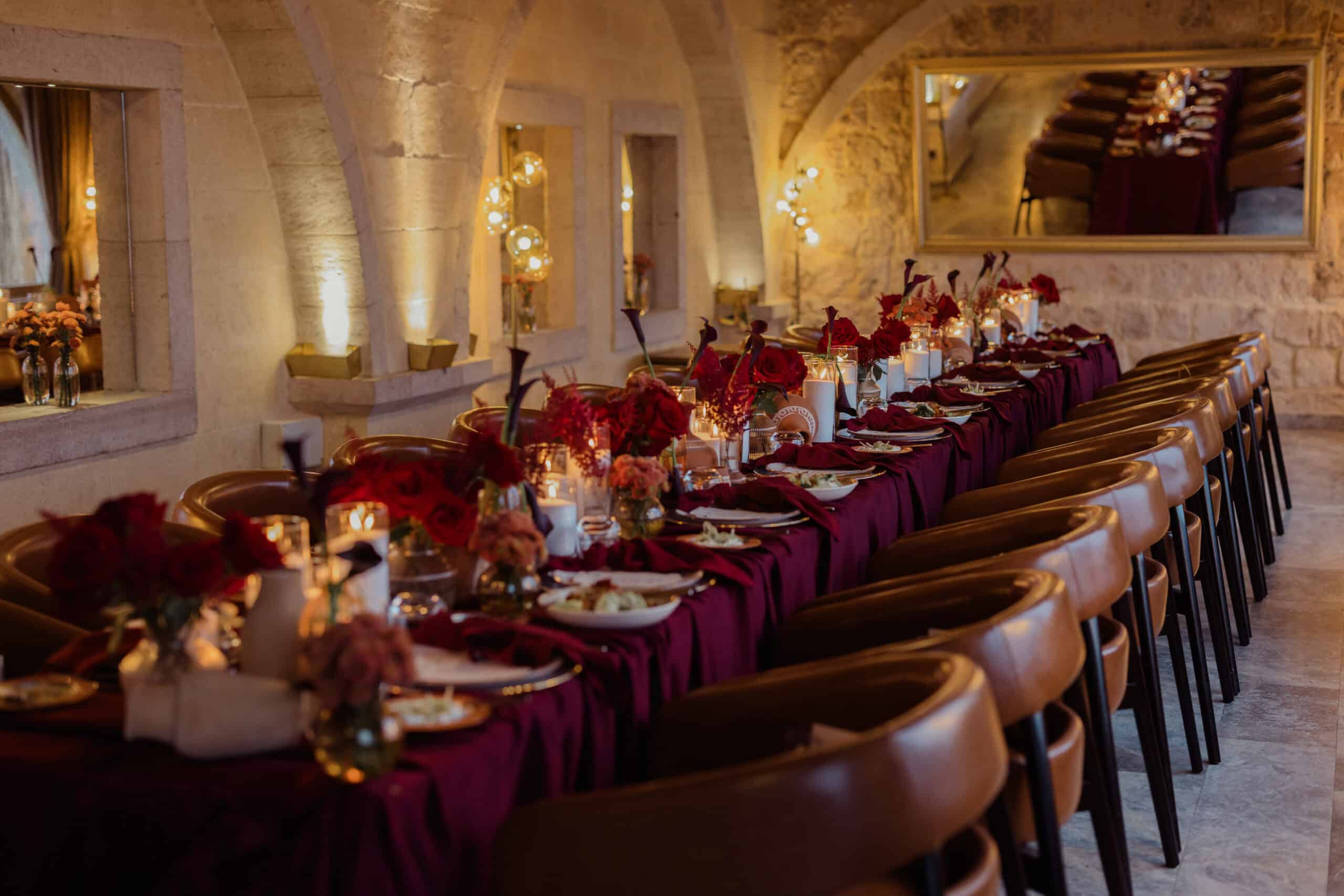 Long banquet table set for a private event in a stone hall