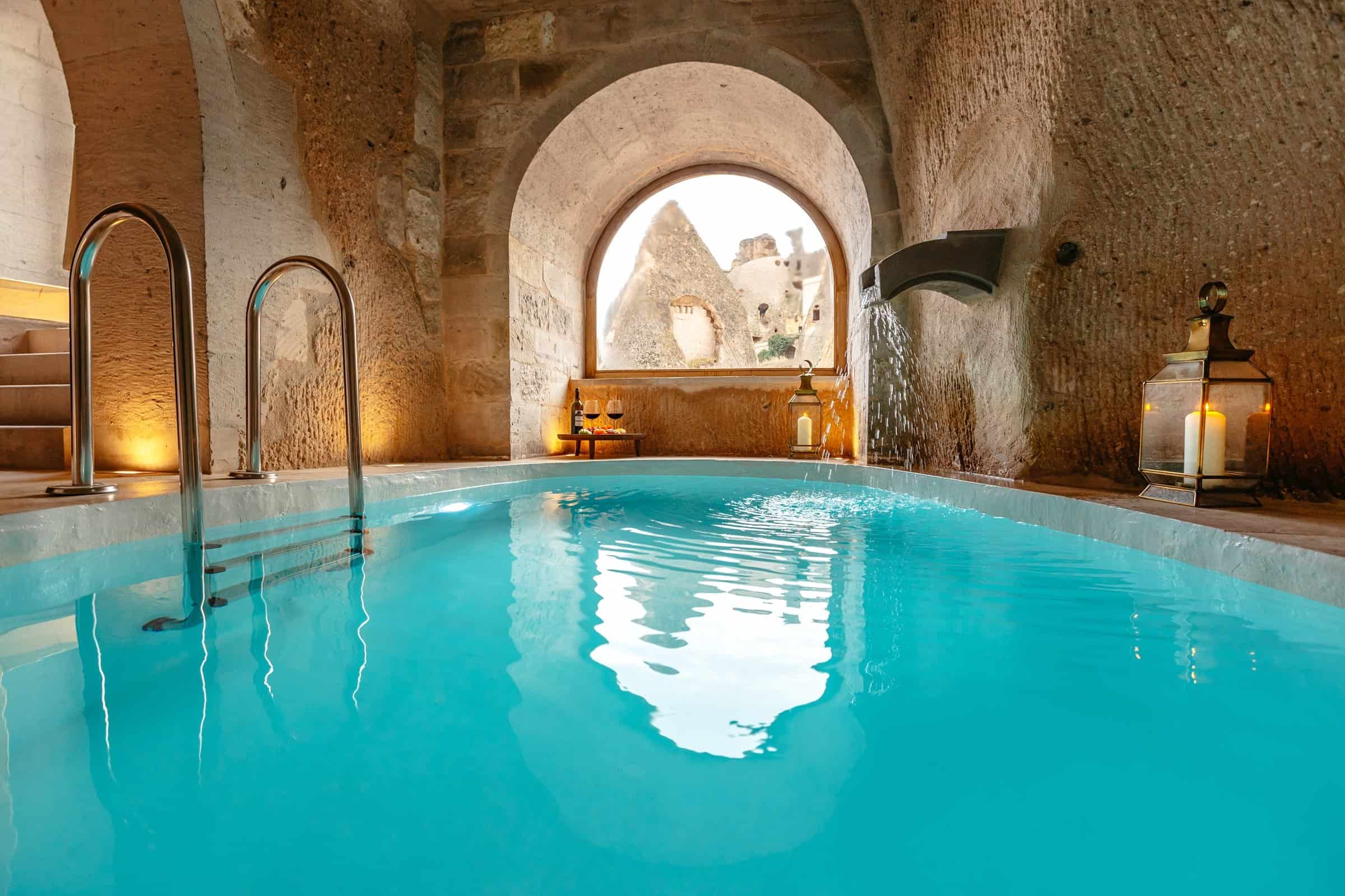 Grand Cave Pool Suite: large indoor cave pool with arched window
