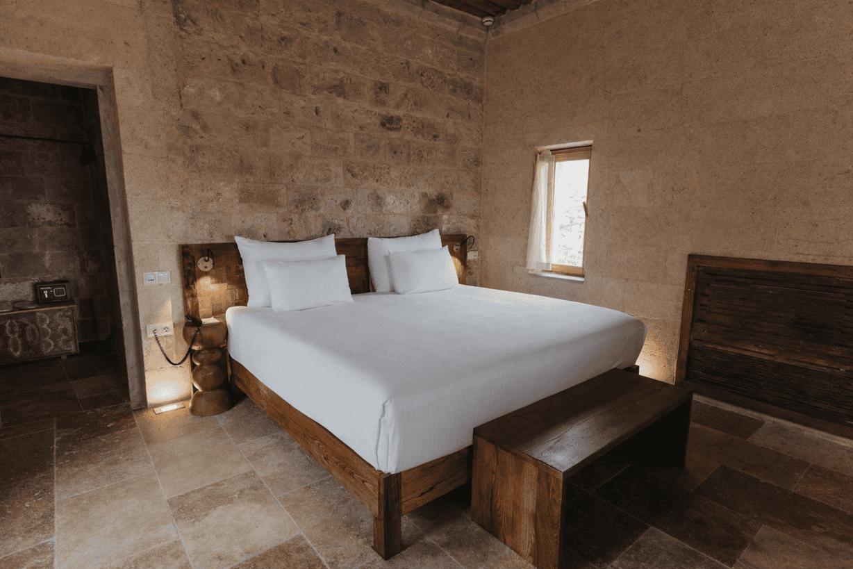 Suite With Balcony: double bed in a stone room