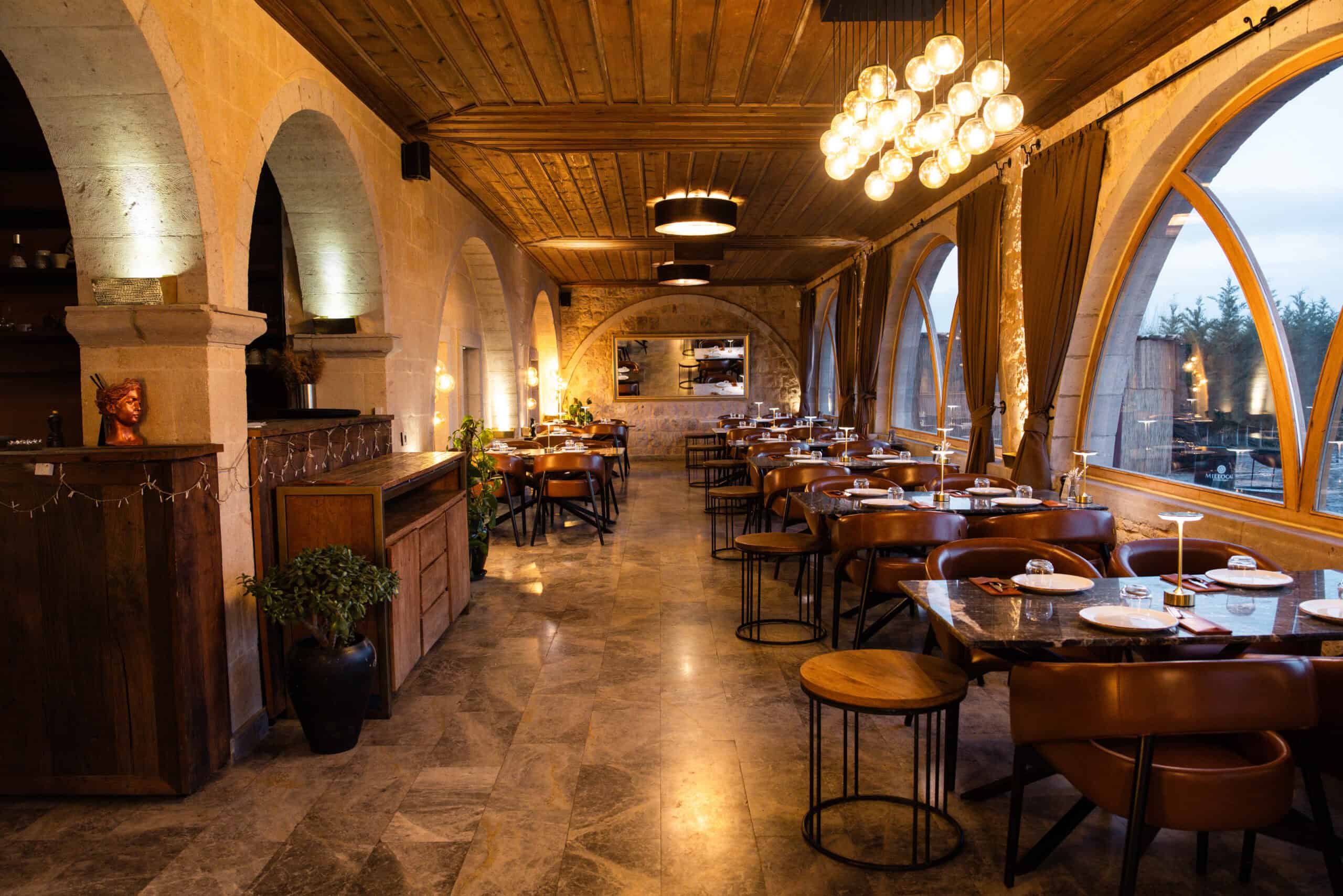 Millocal restaurant with arched windows and wooden ceiling