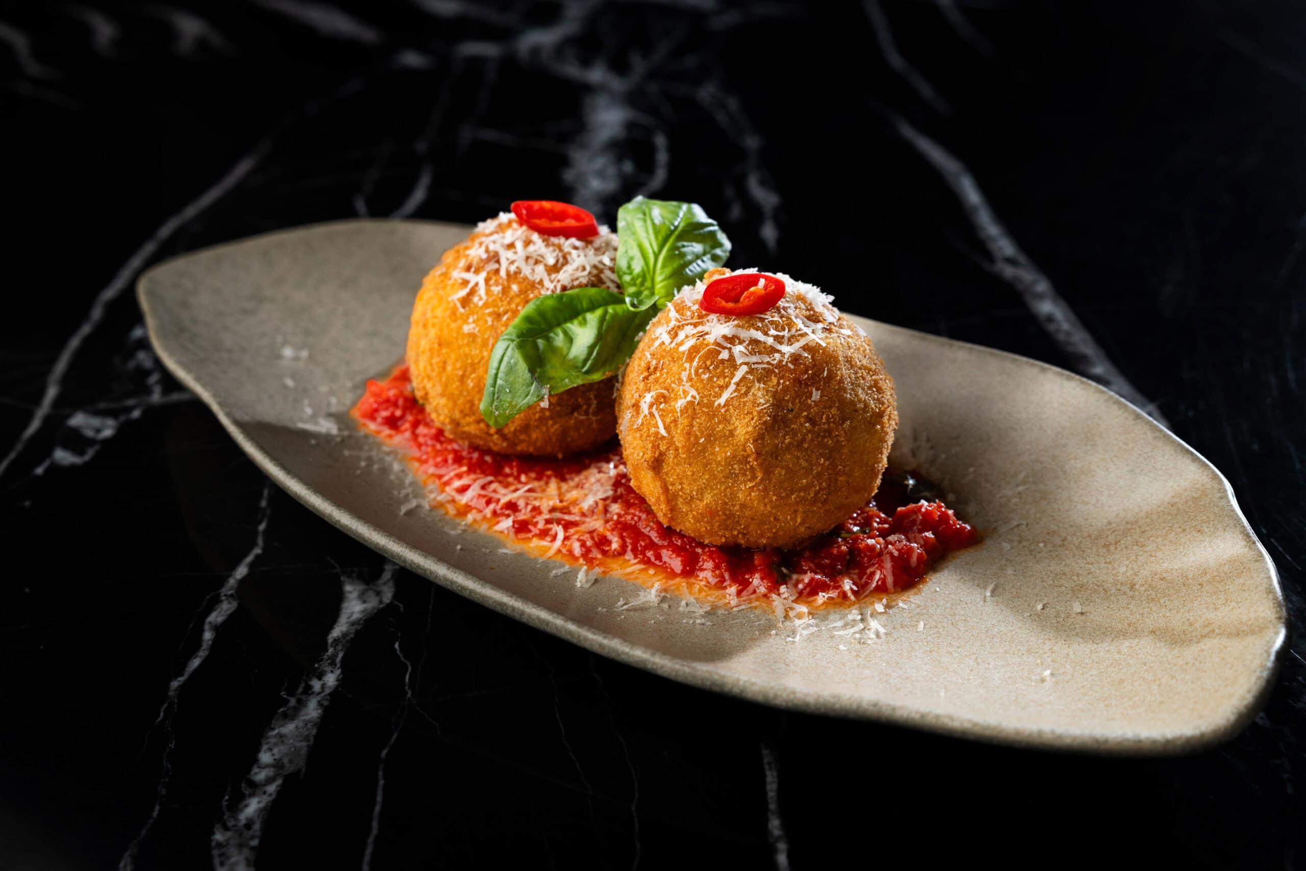 Arancini with tomato sauce and basil