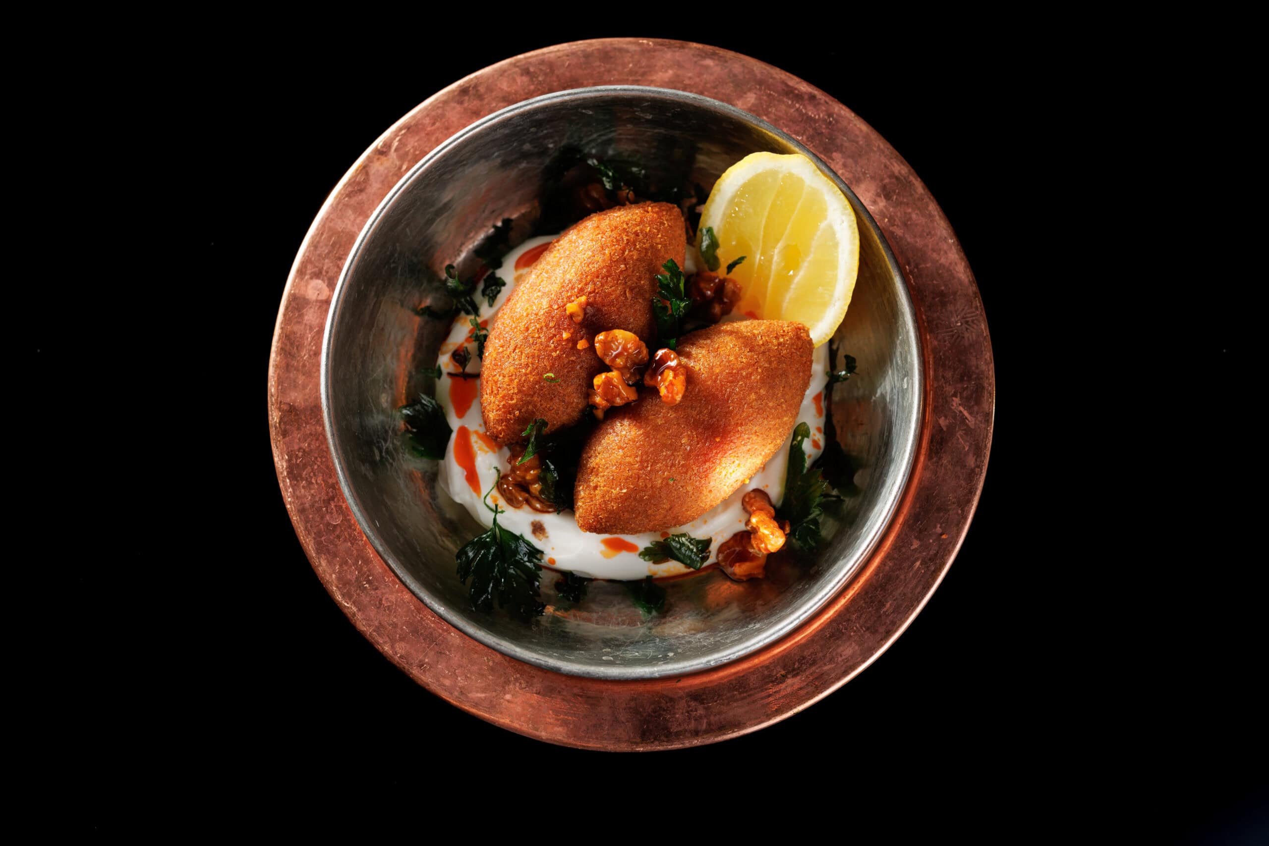 Stuffed dish with lemon served in a copper bowl