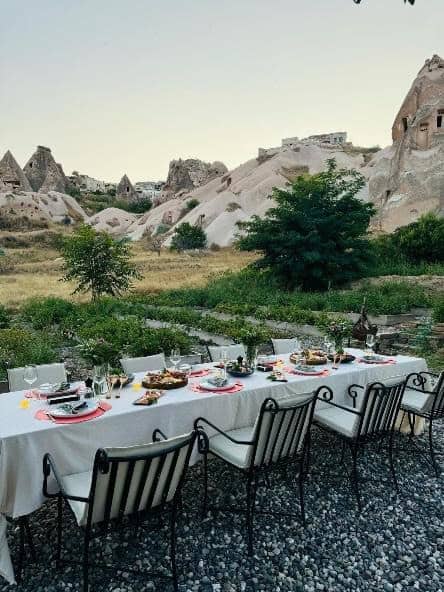 Long outdoor dining table in the garden among the fairy chimneys
