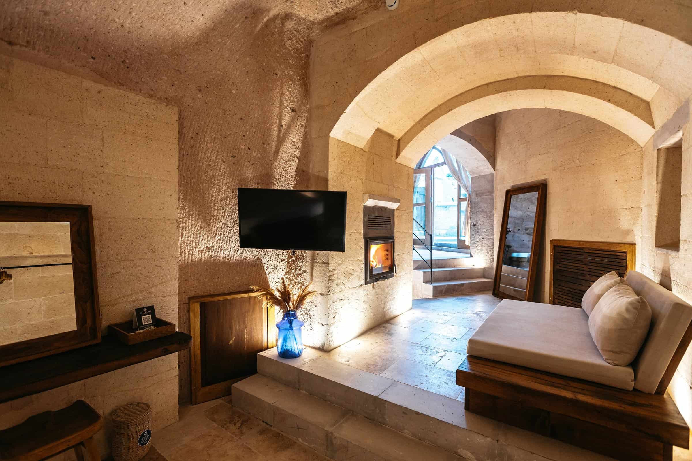 Pool Suite: sitting area with fireplace and arched opening