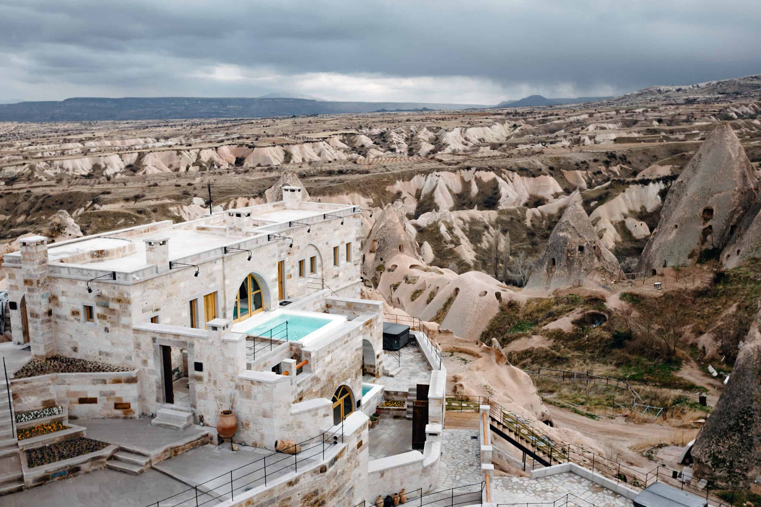 Aerial view of Millstone Cave Suites with its pool and the valleys of Cappadocia