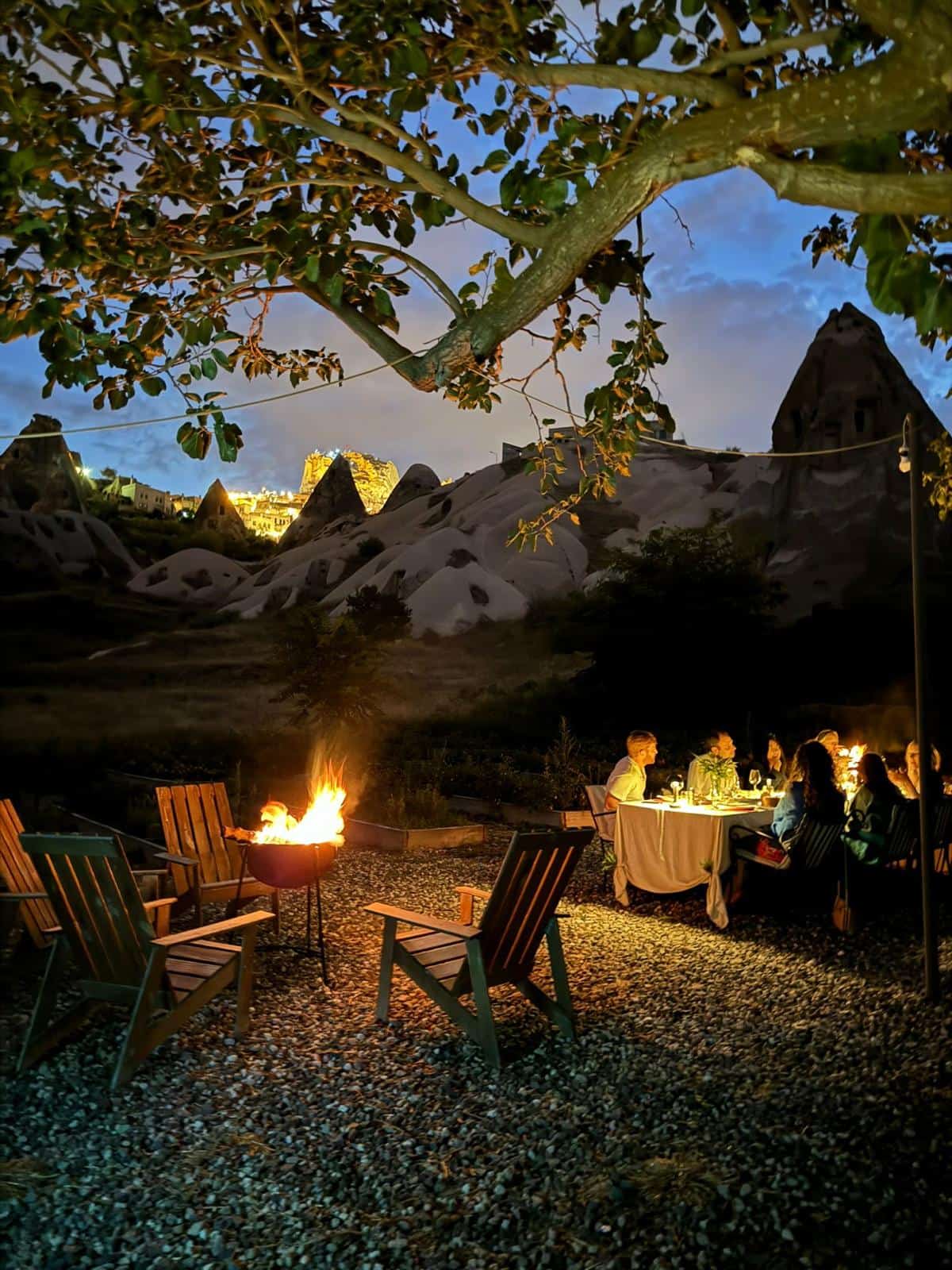 Evening gathering around a fire pit in the garden among the fairy chimneys
