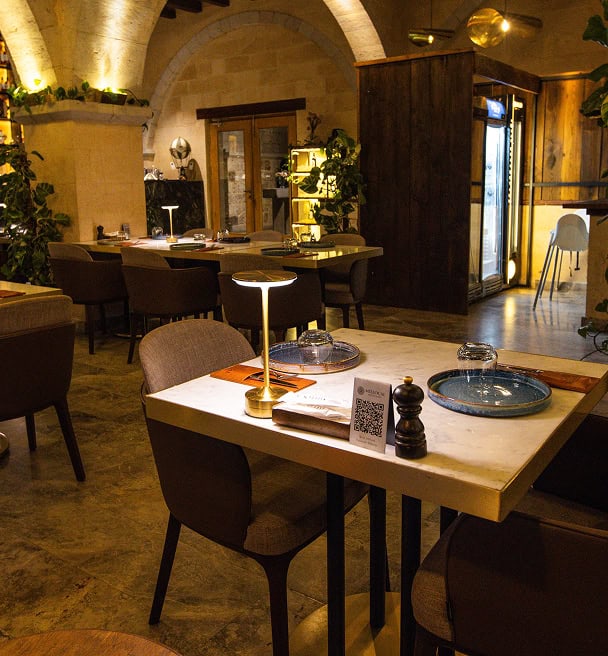 Mill Italy restaurant interior with stone walls and wooden tables