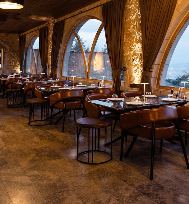 Dining room with tall arched windows at Mill Italy