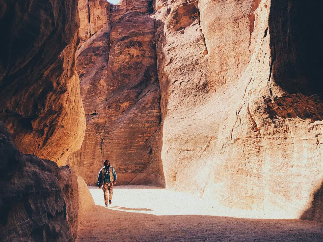 Hiker walking through a narrow rock canyon in Cappadocia