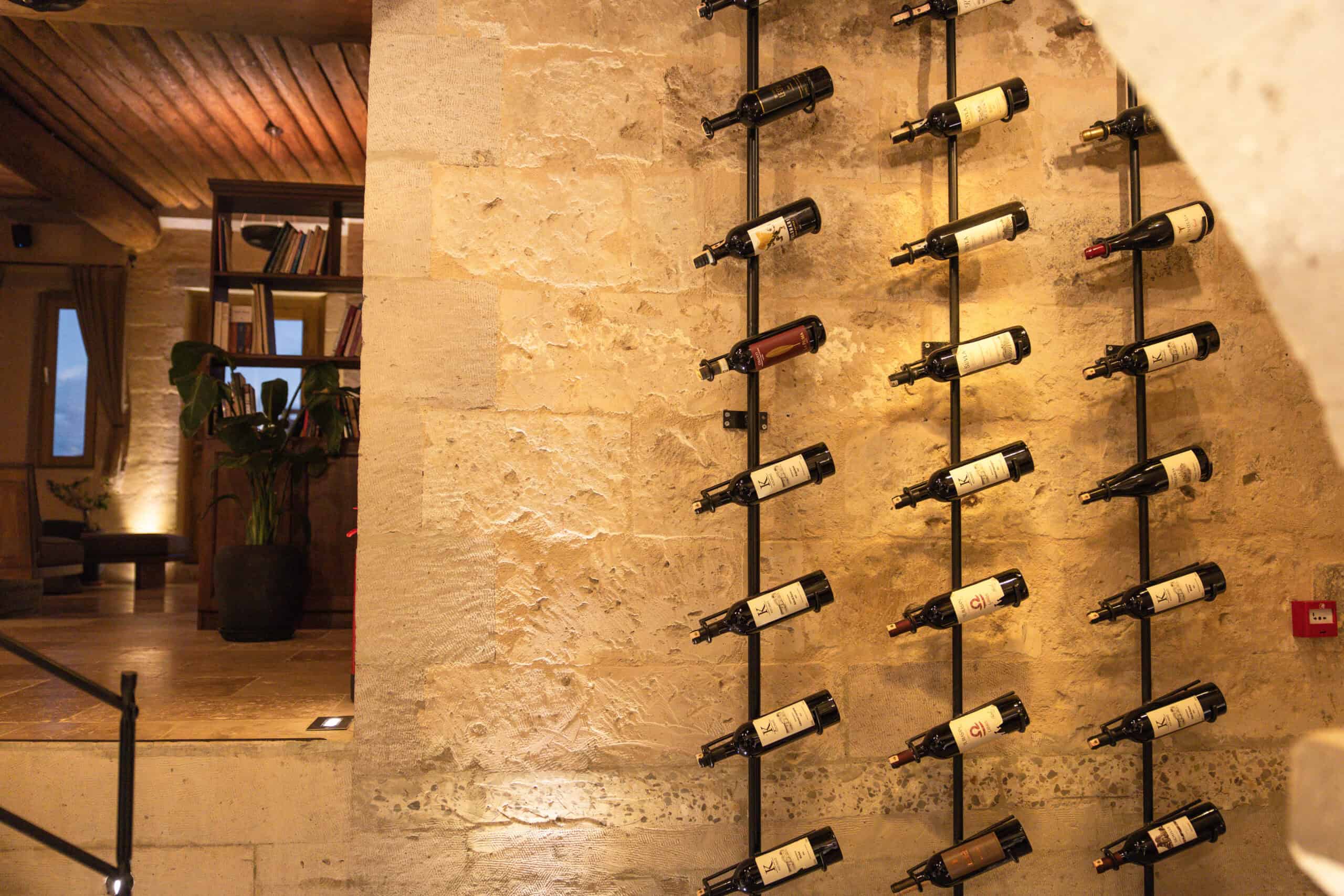 Wine bottles displayed on a stone wall